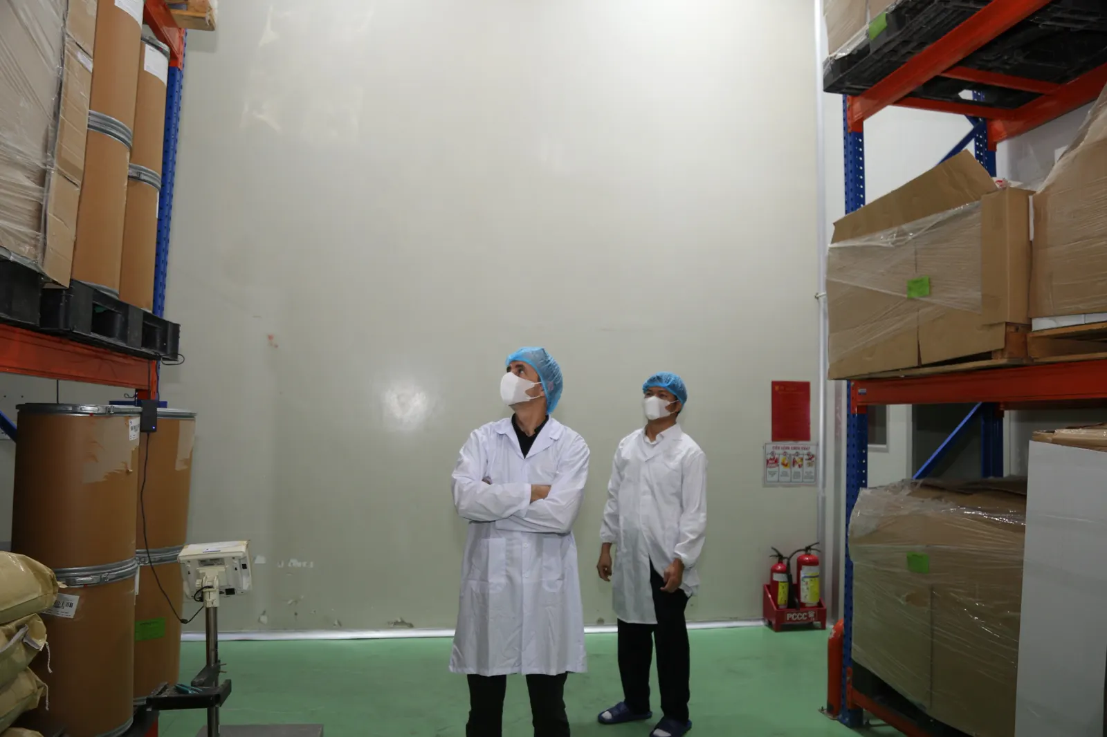 Raw materials on pallet racks, with a weighing scale
